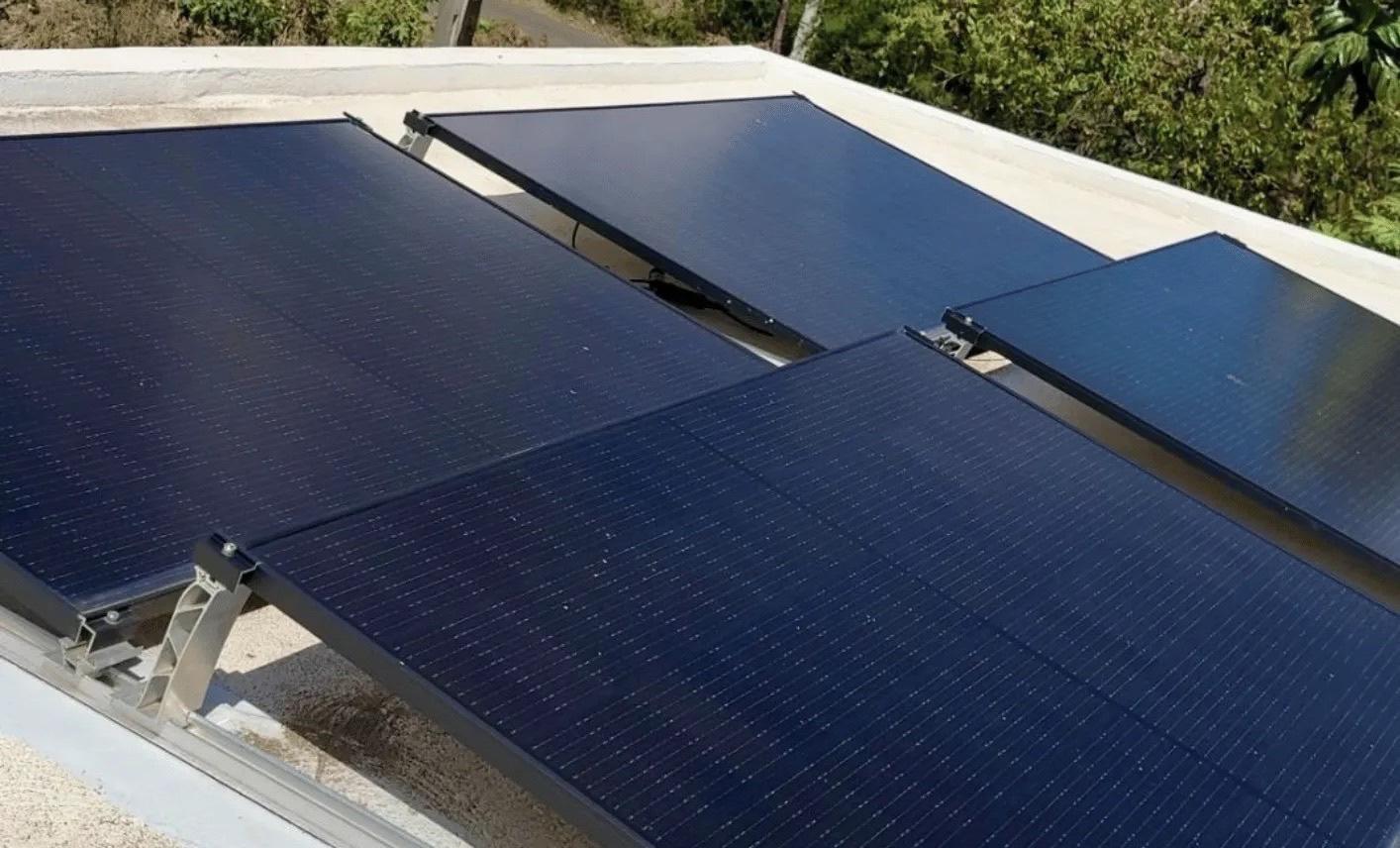 Solar panels installed by Grubbs Energy on a family home roof in Pointe aux Sables